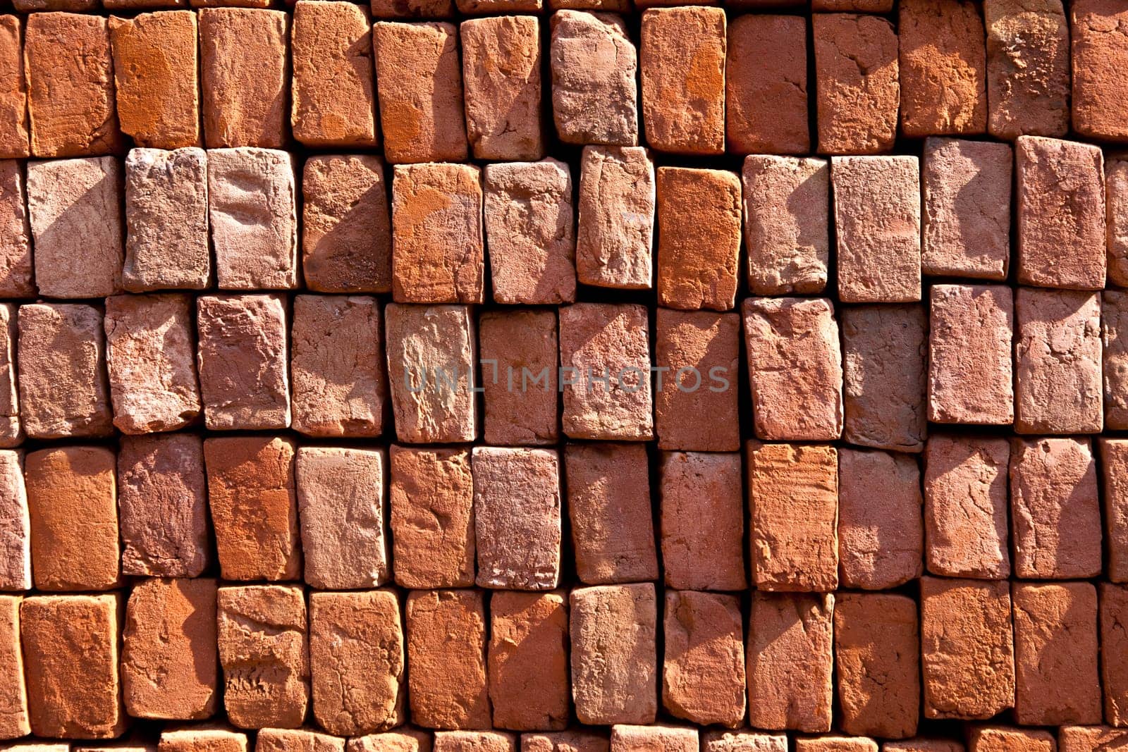 red stapled bricks give a harmonic pattern in the sun