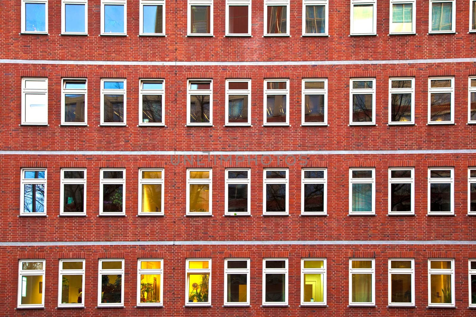facade of office building in the evening with illuminated windows