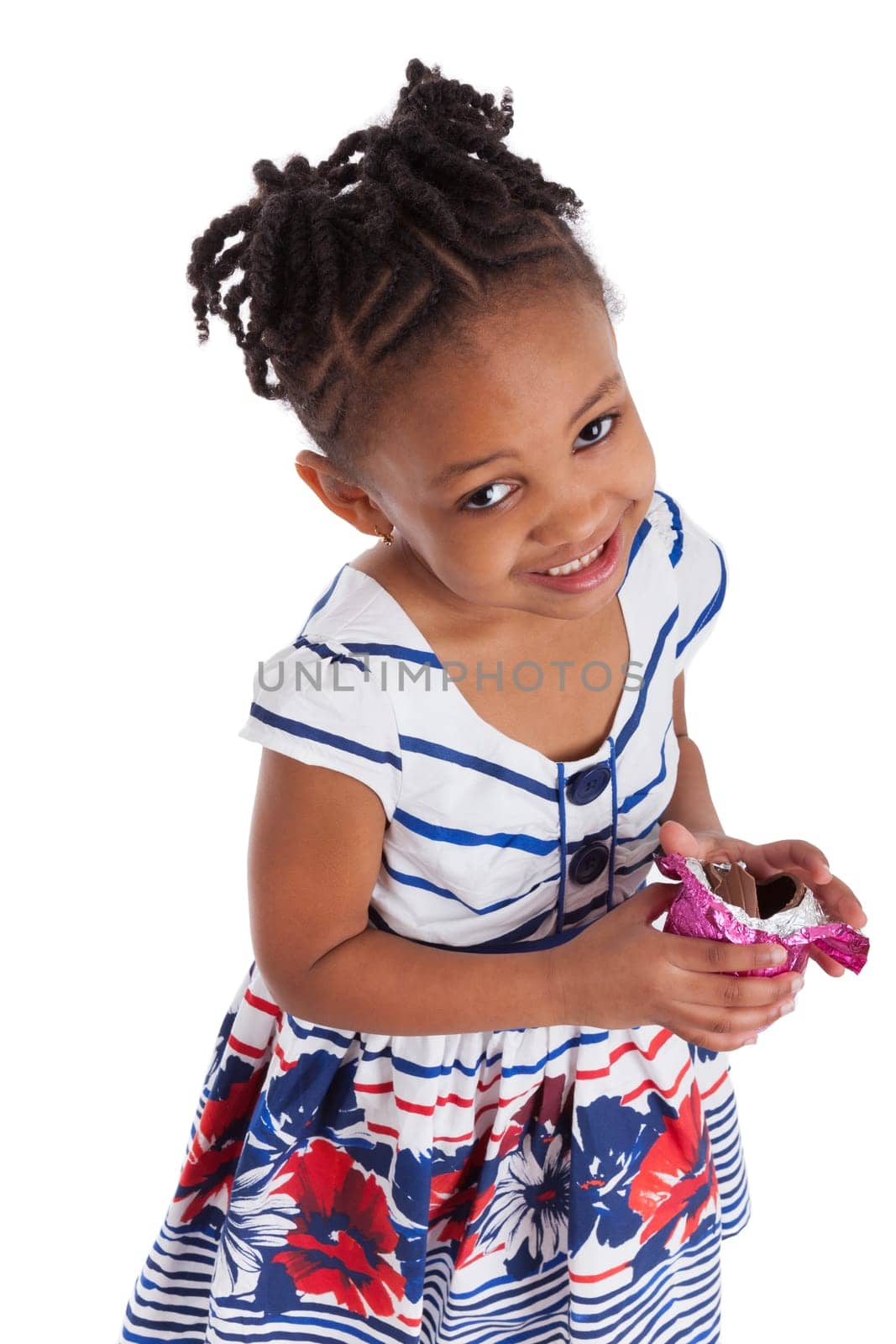 Little african american girl eating chocolate easter egg, isolated on white background