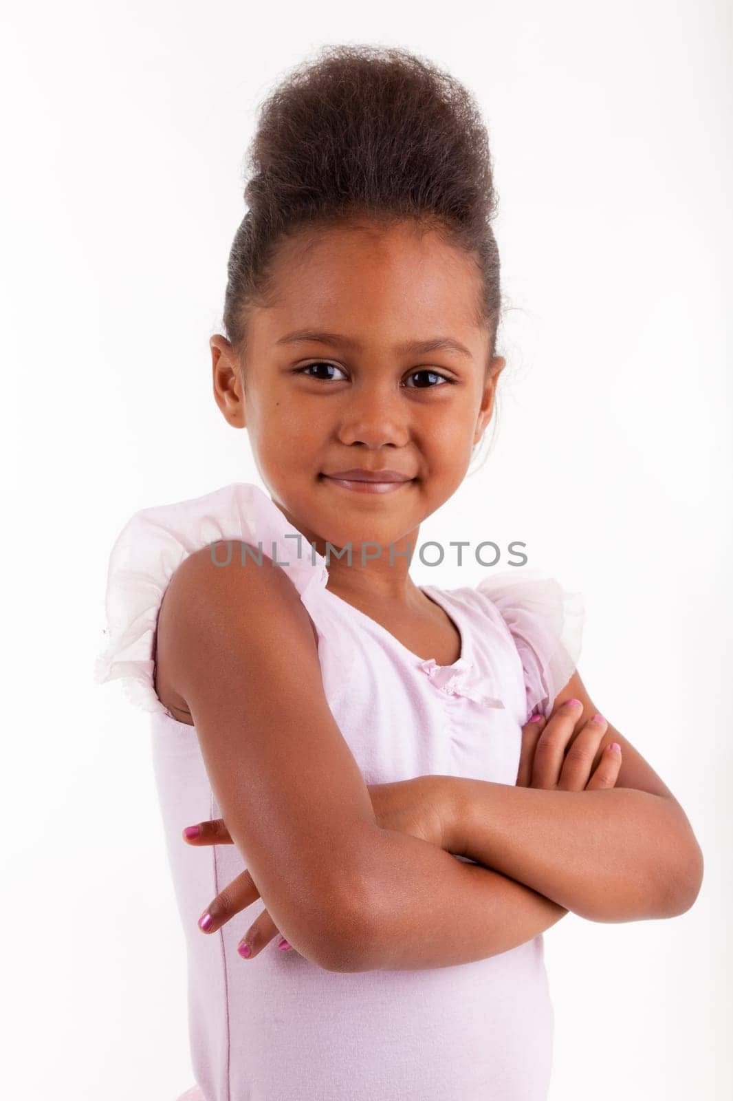 Cute little African Asian girl smiling ,with folded arms