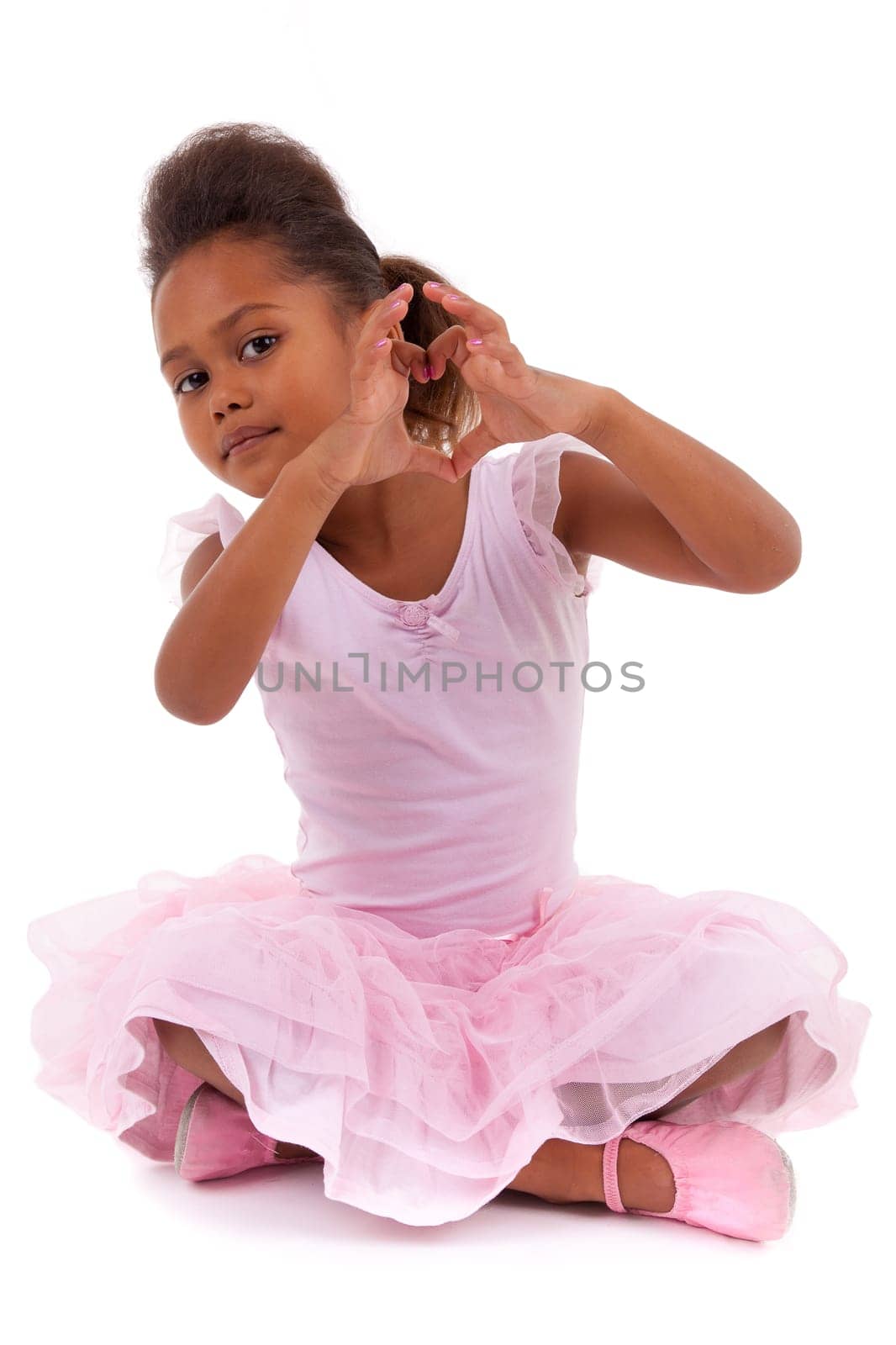 Cute little African Asian girl sitting on the floor,  isolated on white background