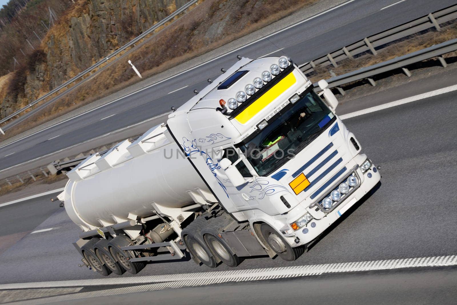 large white fuel-truck driving on freeway