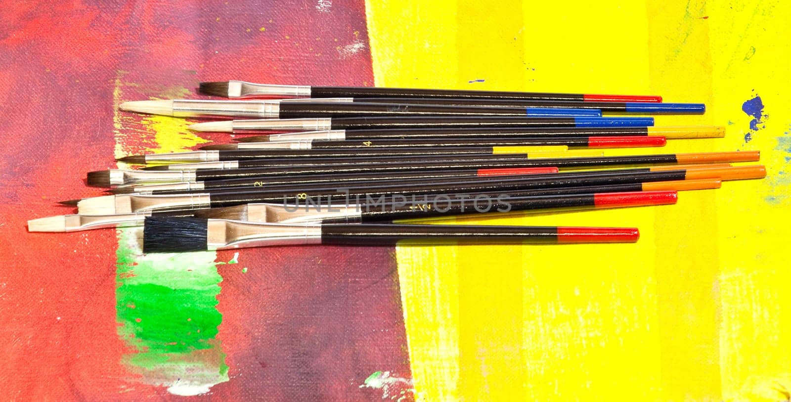 Paintbrushes on colorful background
