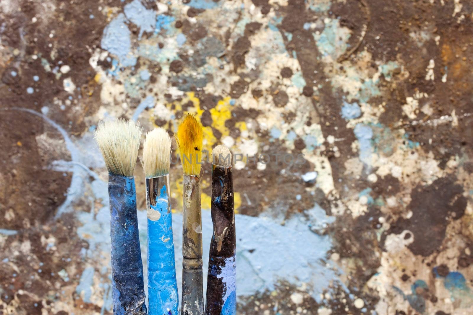 Paintbrushes on colorful background