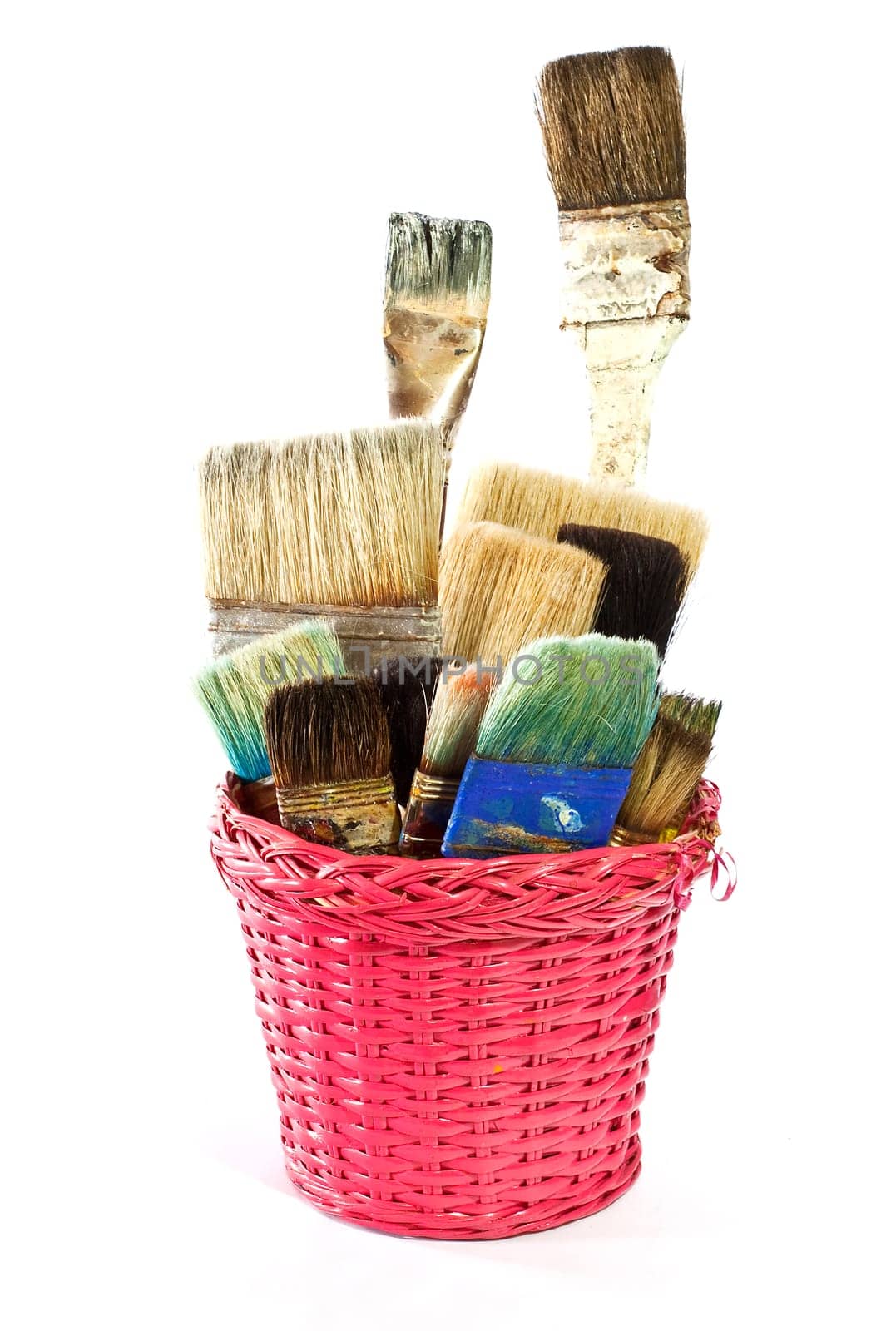 Various used Paintbrushes in a wicker basket