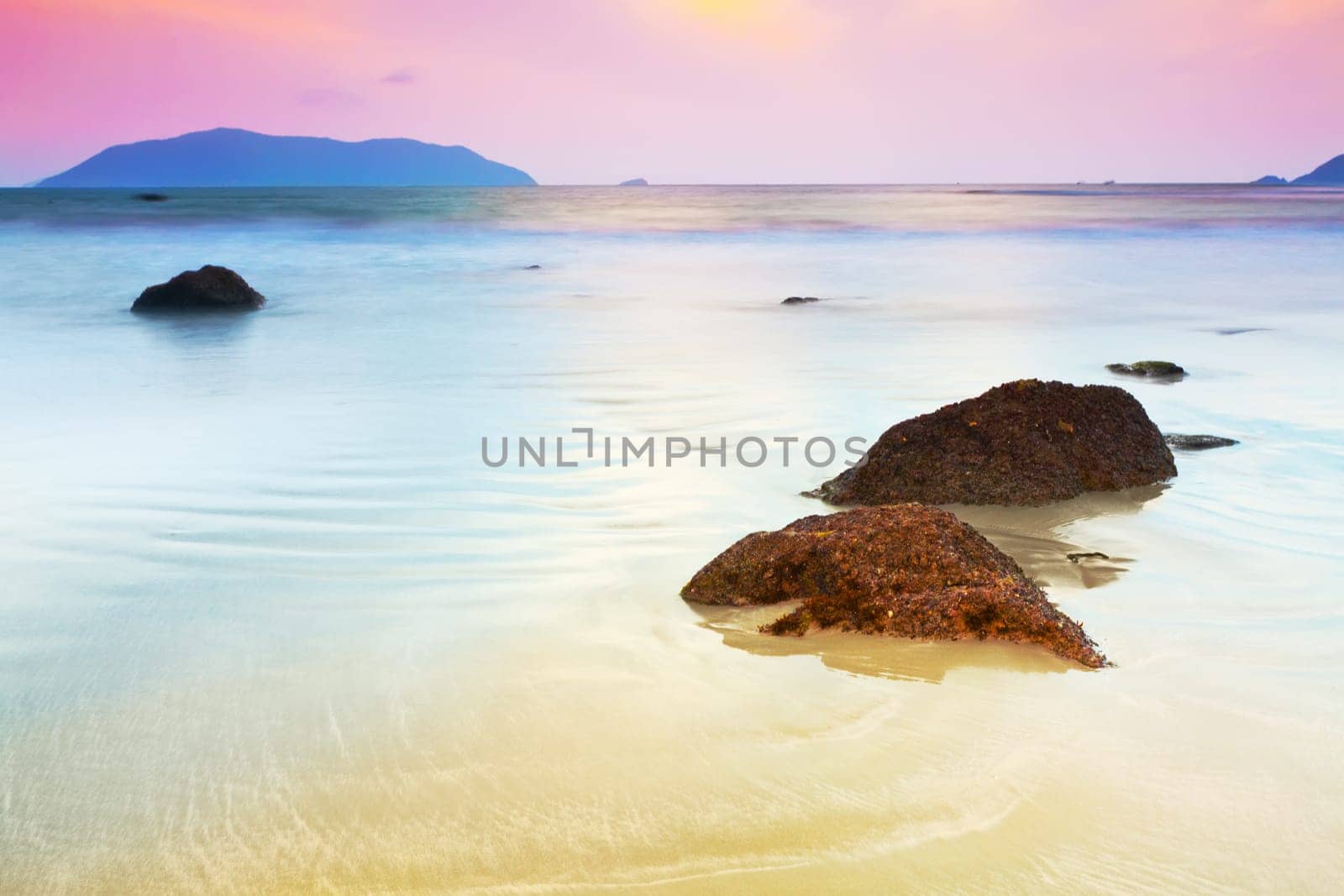 Sunrise over the sea. Stone on the foreground
