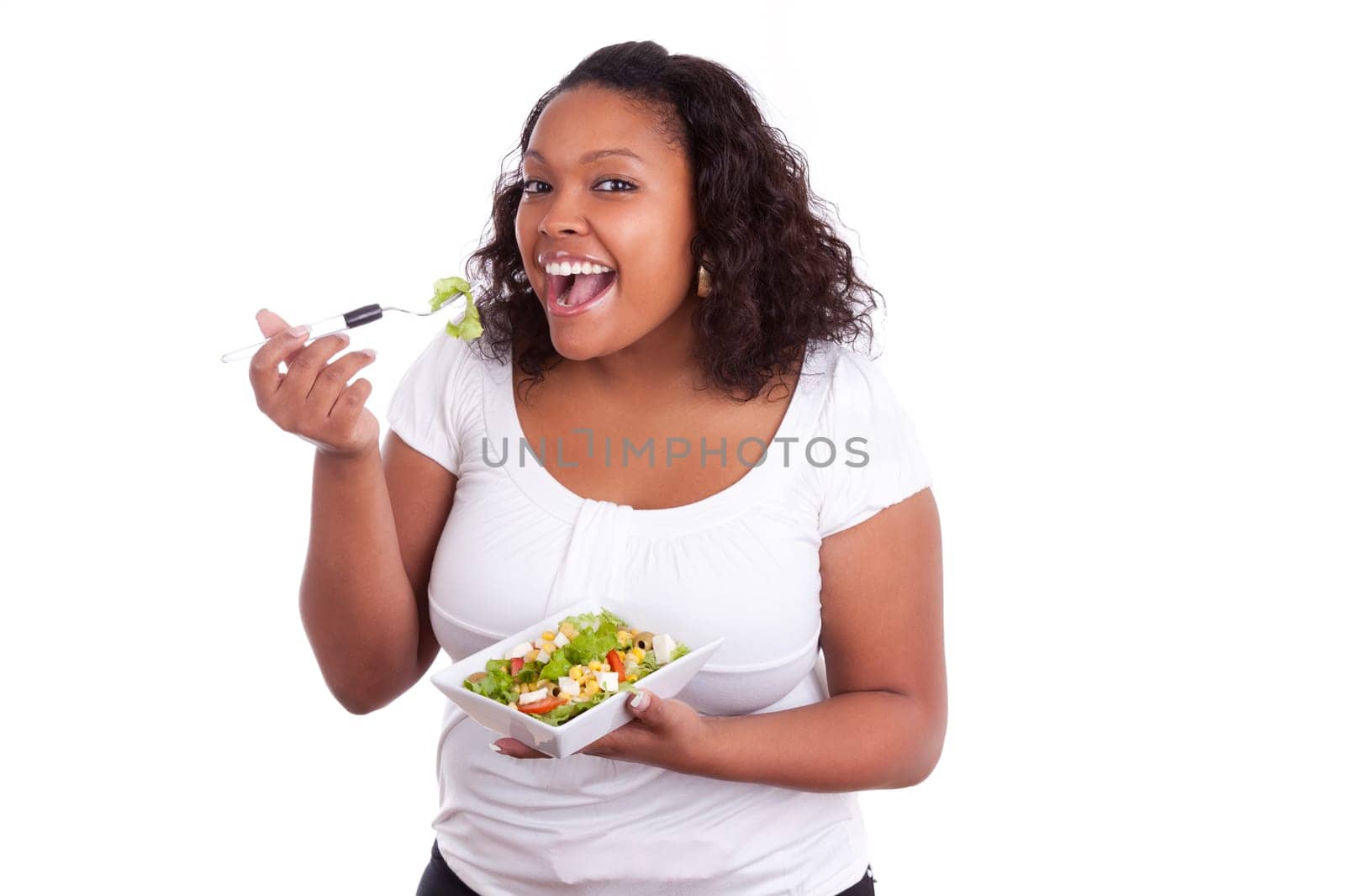Young african american woman eating salad, isolated on white background