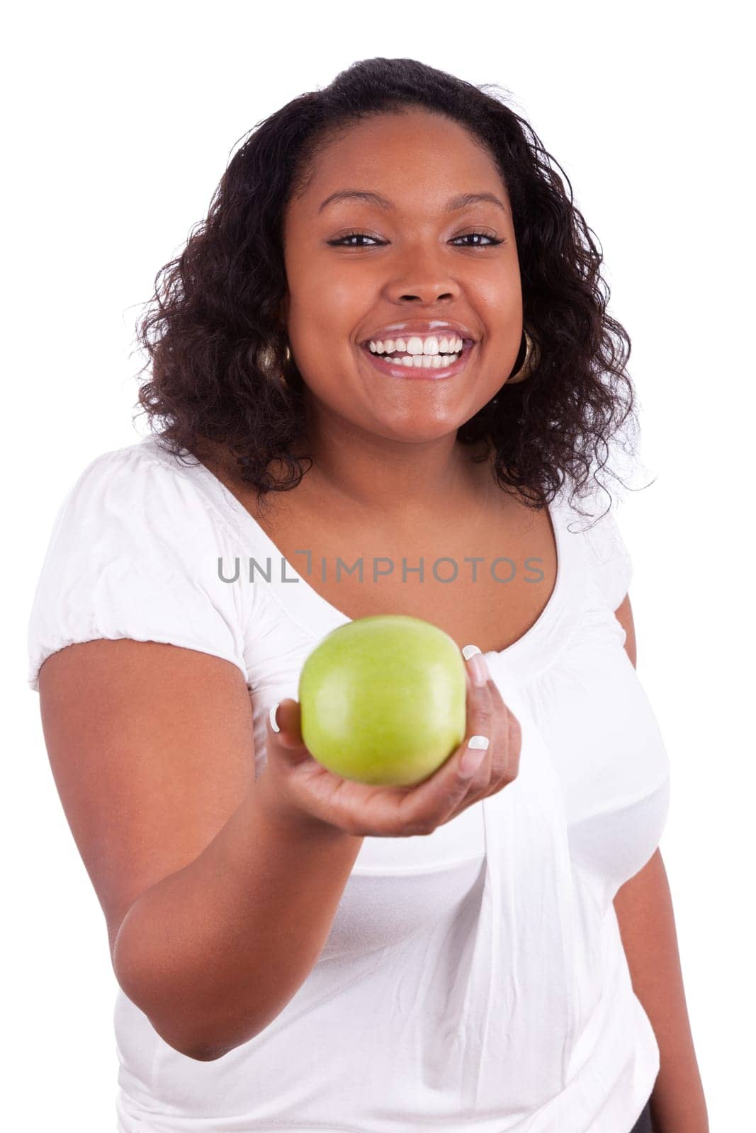 Young african american woman giving an  green apple, isolated on white background