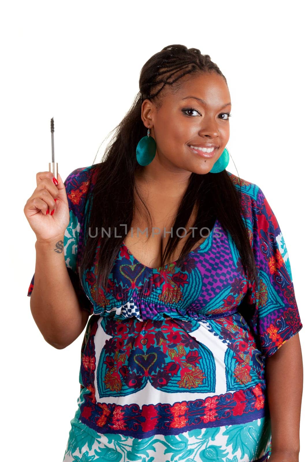 Young beautiful black woman applying mascara, isolated on white background