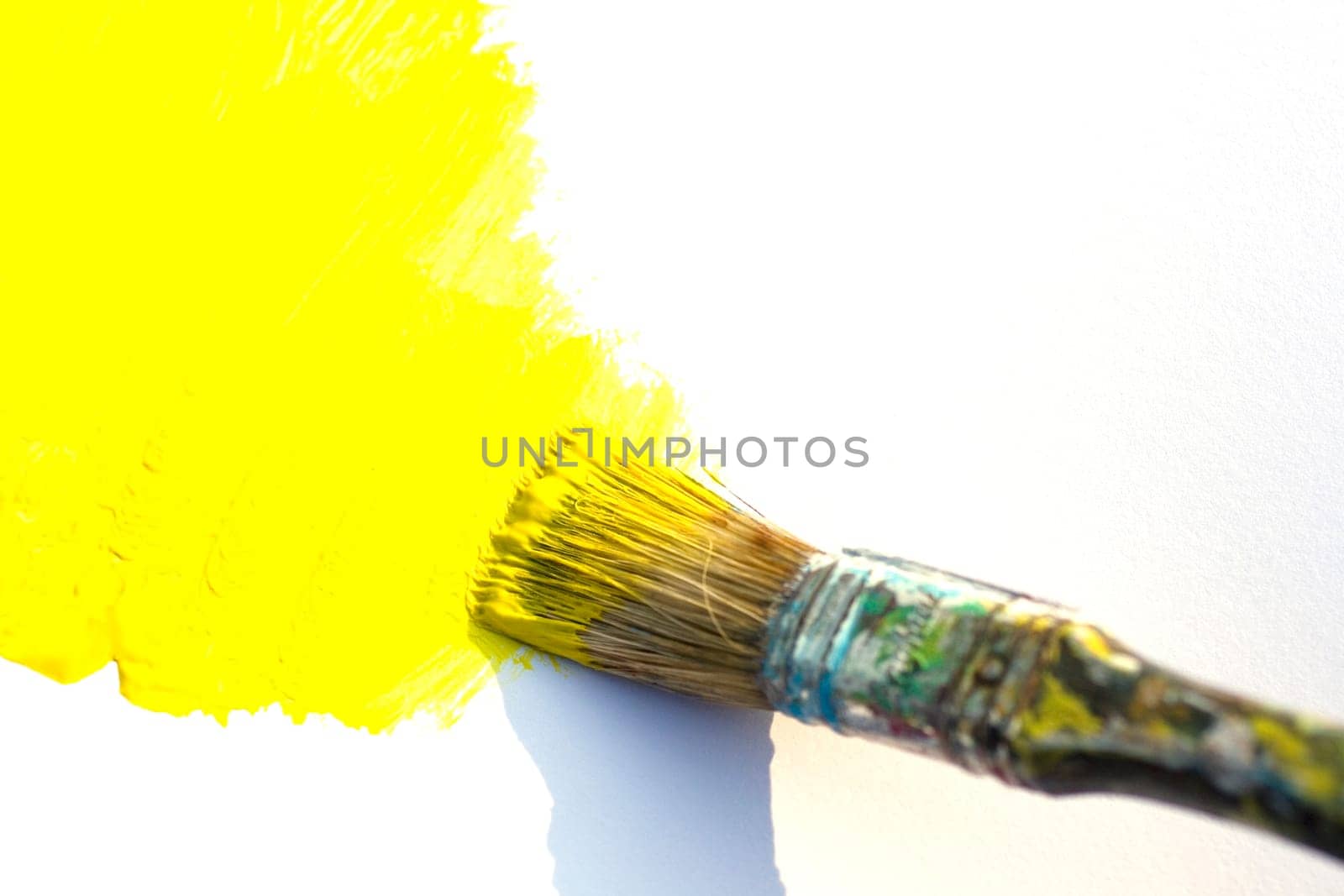 Paintbrush and yellow on white