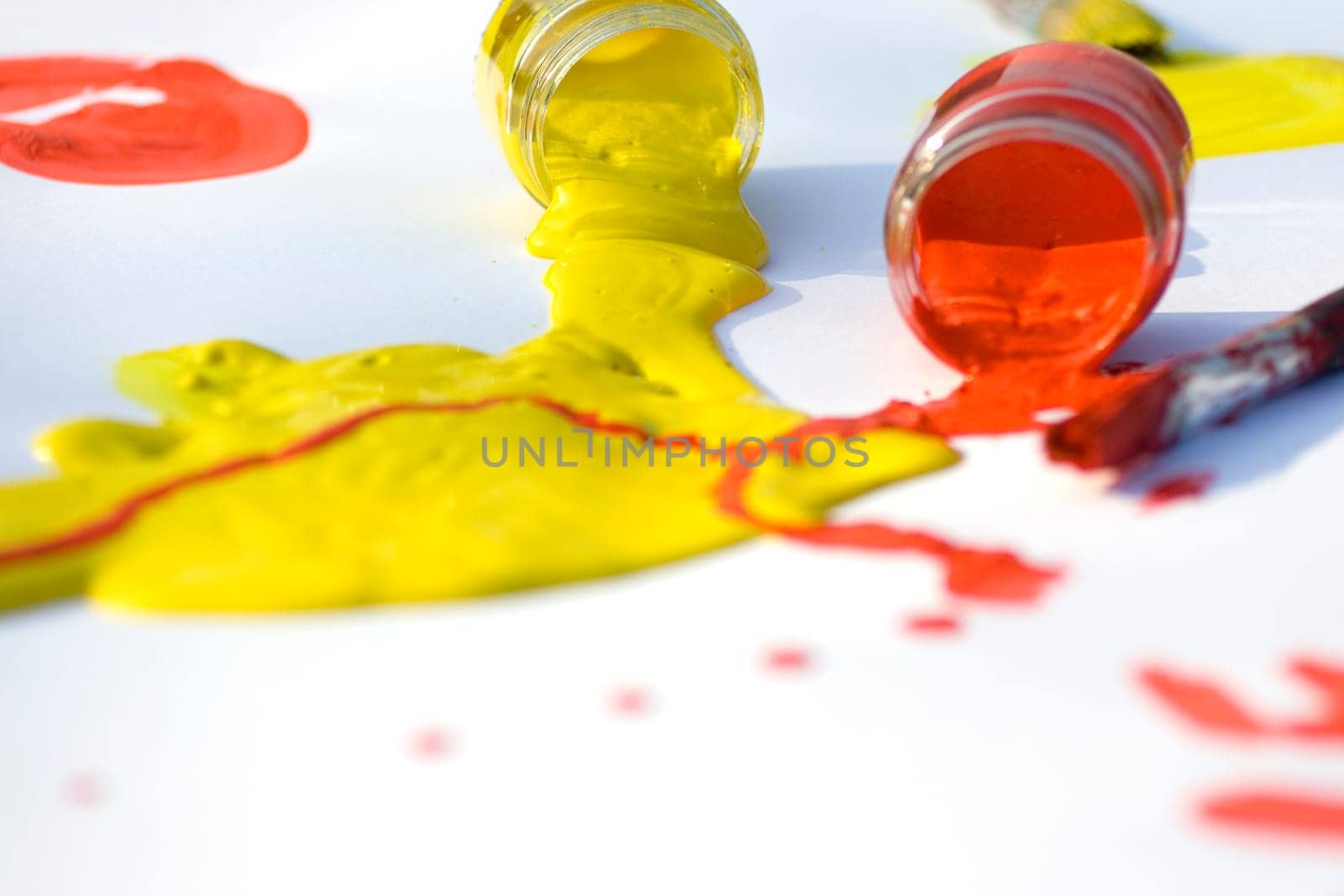 Photo of Yellow and red colors and paintbrush