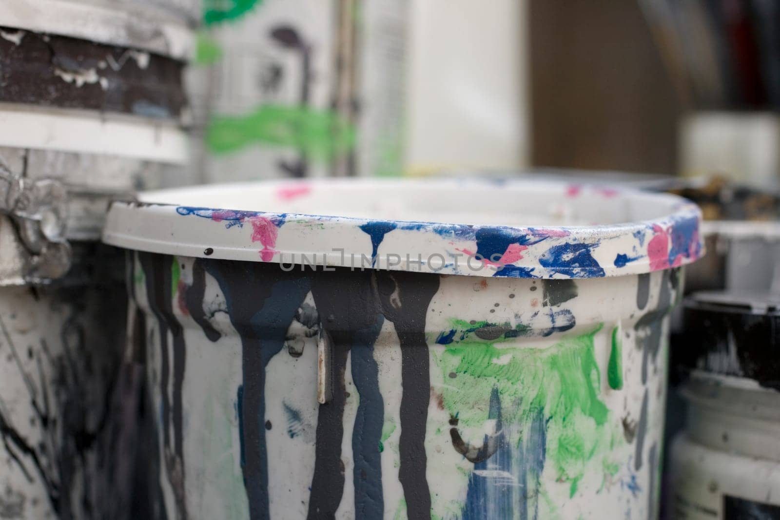 Photo of dirty plastic containers of paint