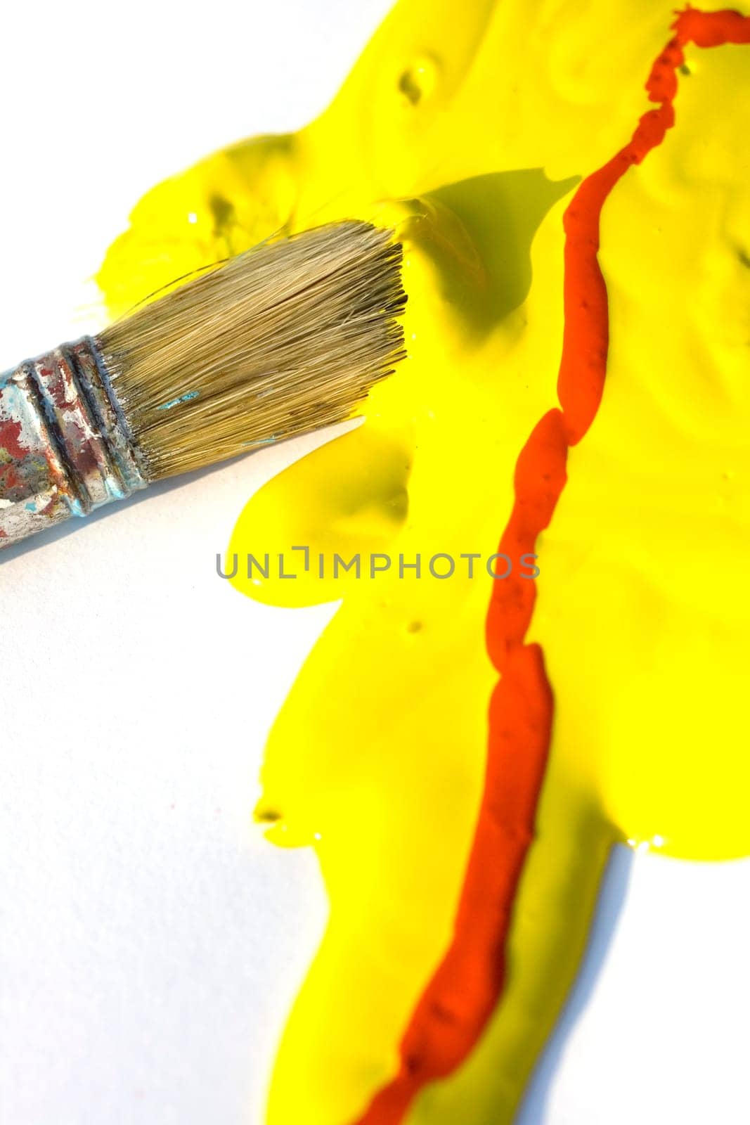 Photo of Yellow and red colors and paintbrush