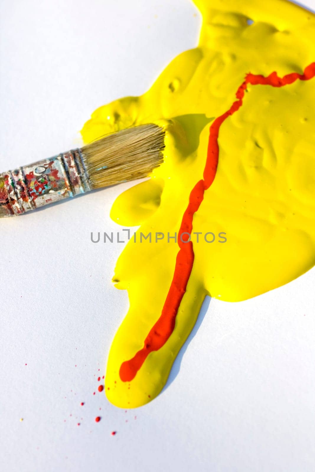 Photo of Yellow and red colors and paintbrush