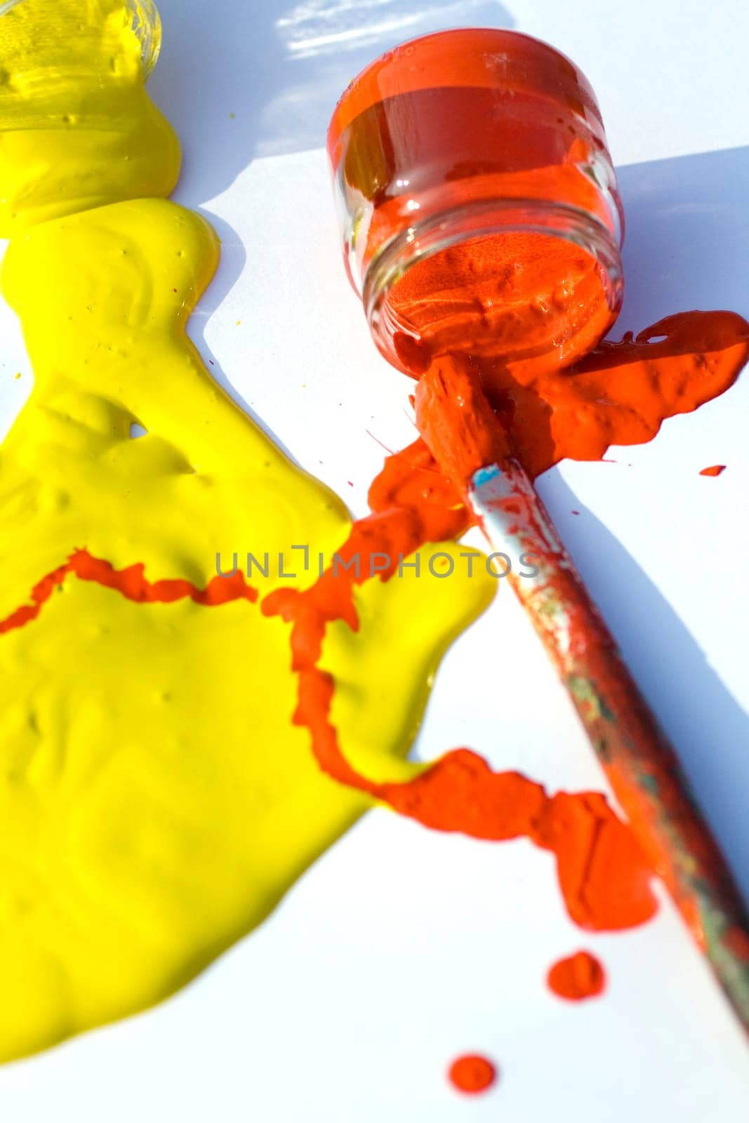 Photo of Yellow and red colors and paintbrush