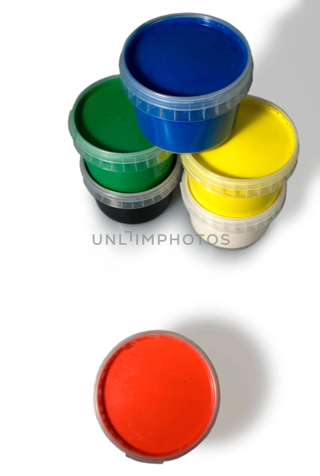 Jars of blue, yellow, red, white green and black colors isolated on a white background