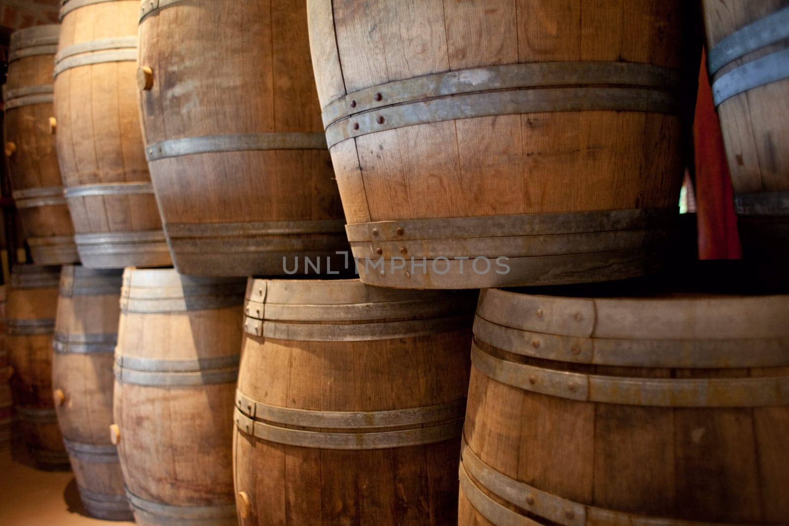 Barrels of South African wine in a wine cellar