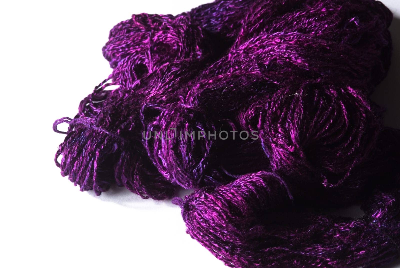 Handmade bundle of purple yarn on white