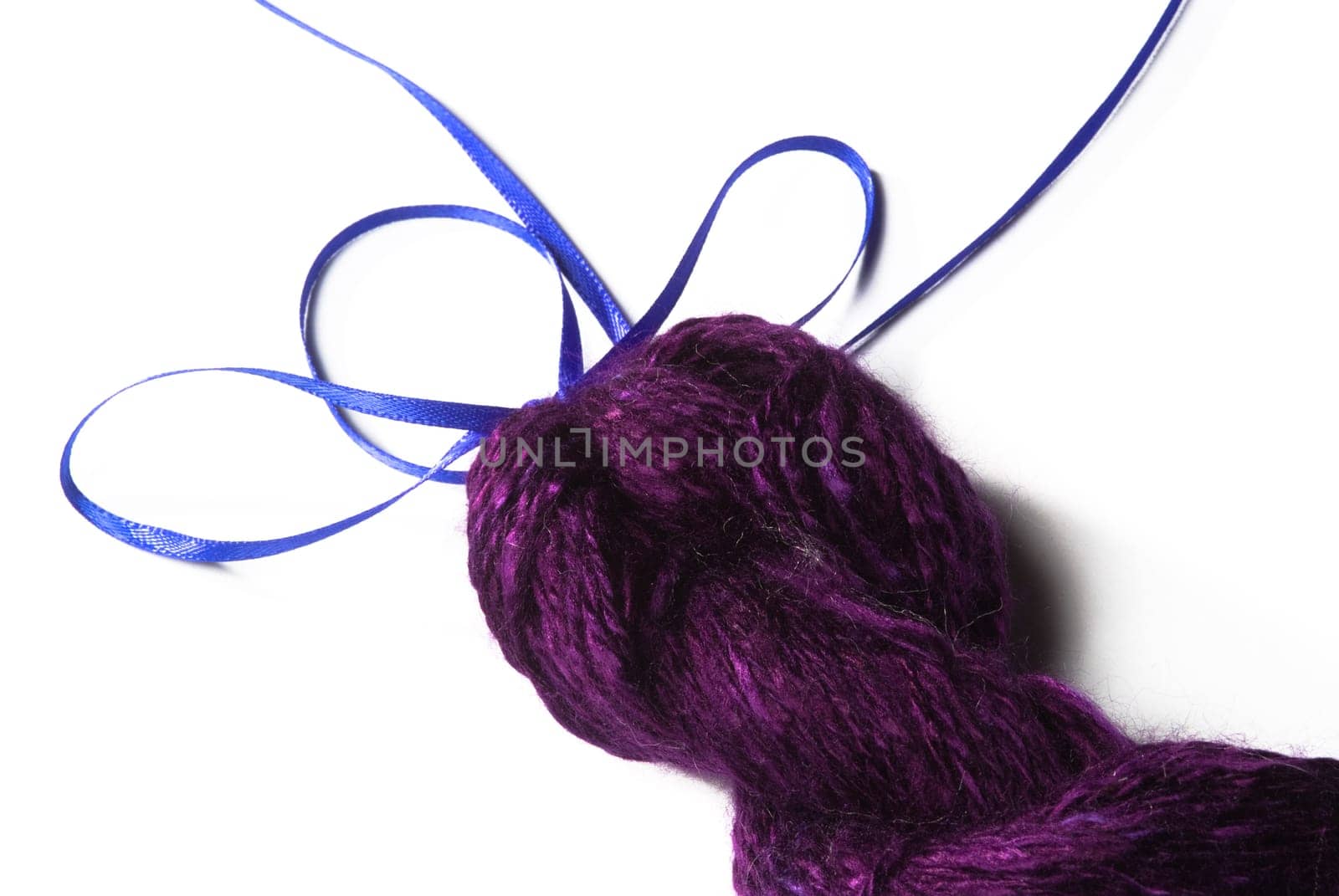 Handmade bundle of purple yarn on white