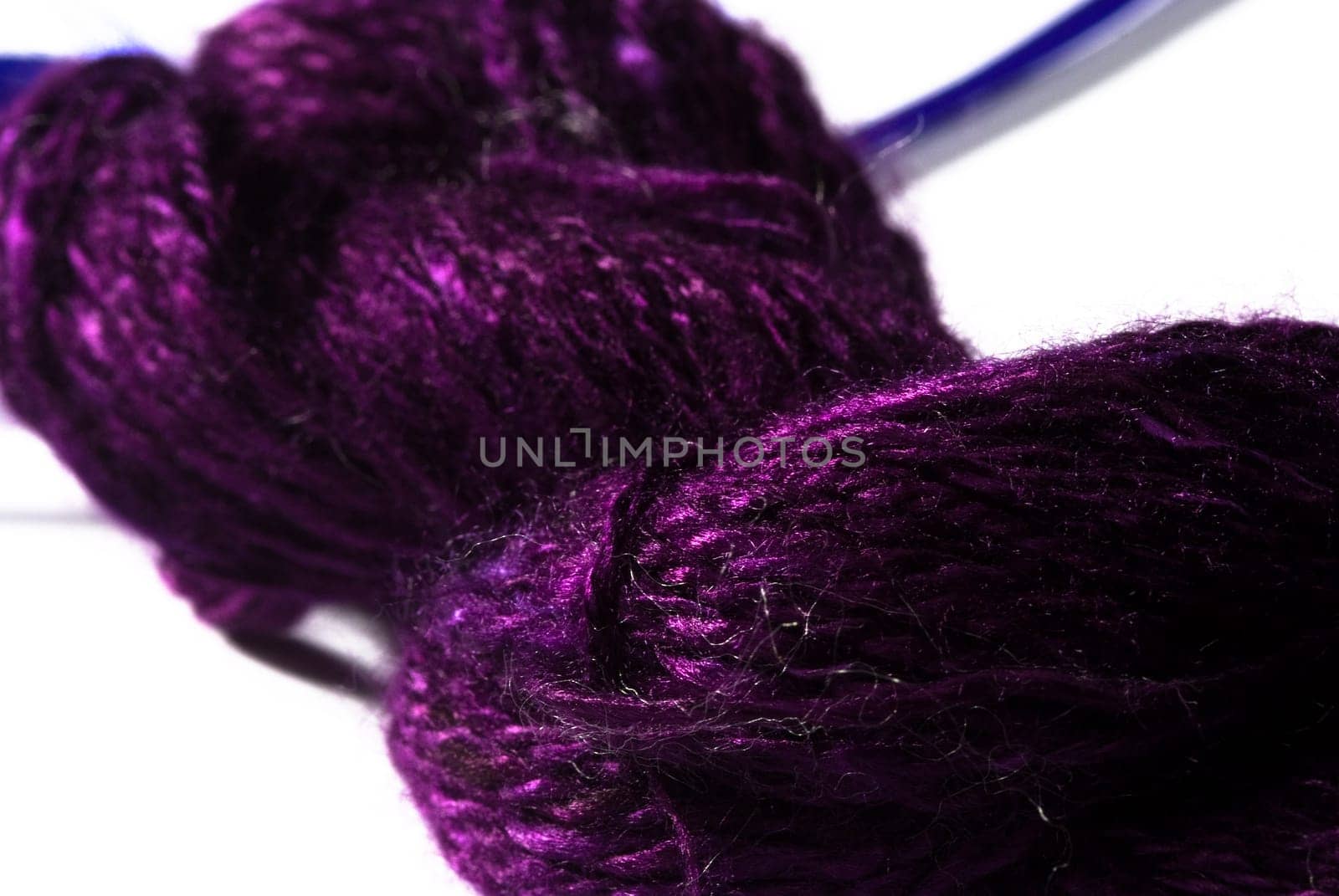 Handmade bundle of purple yarn on white