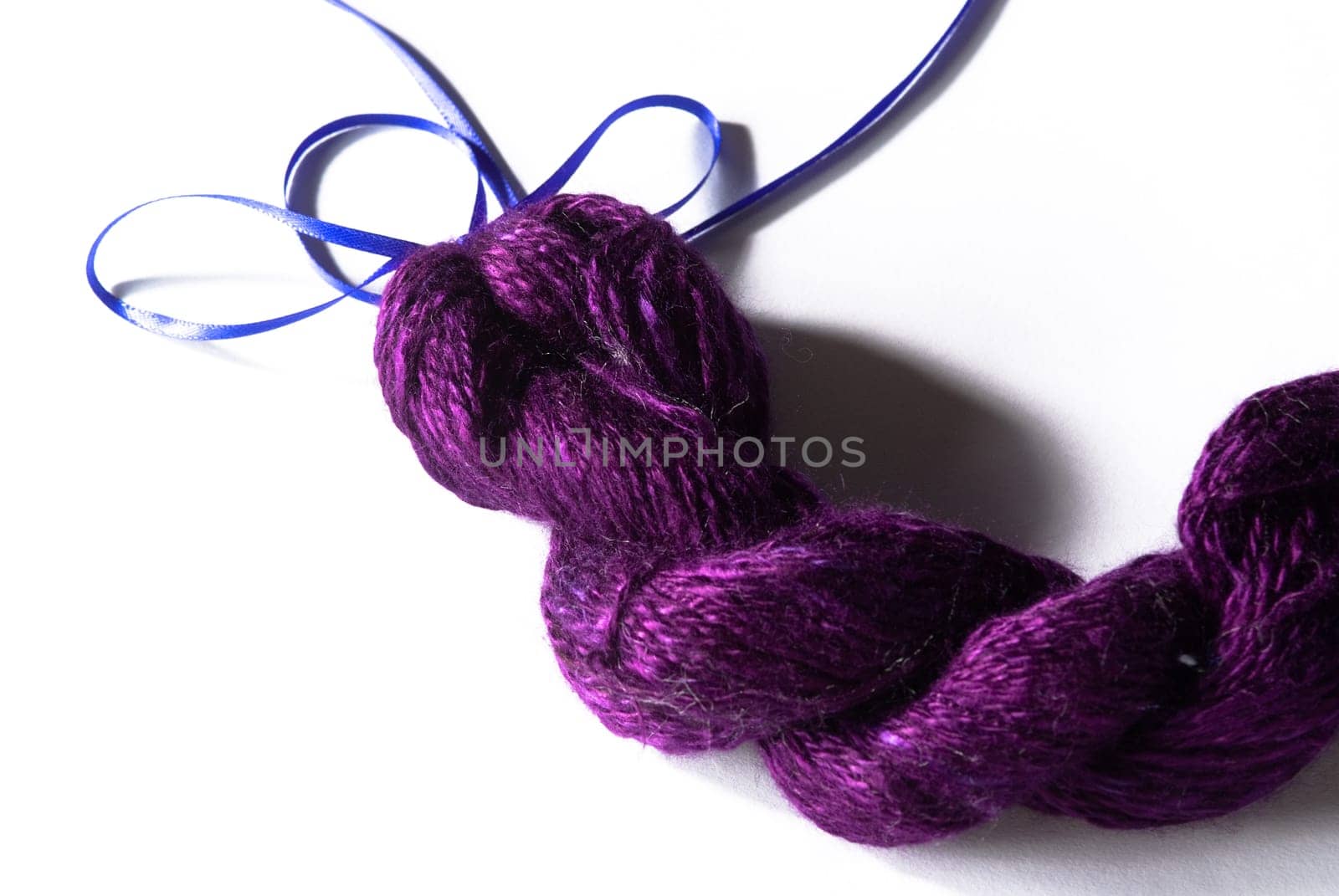 Handmade bundle of purple yarn on white