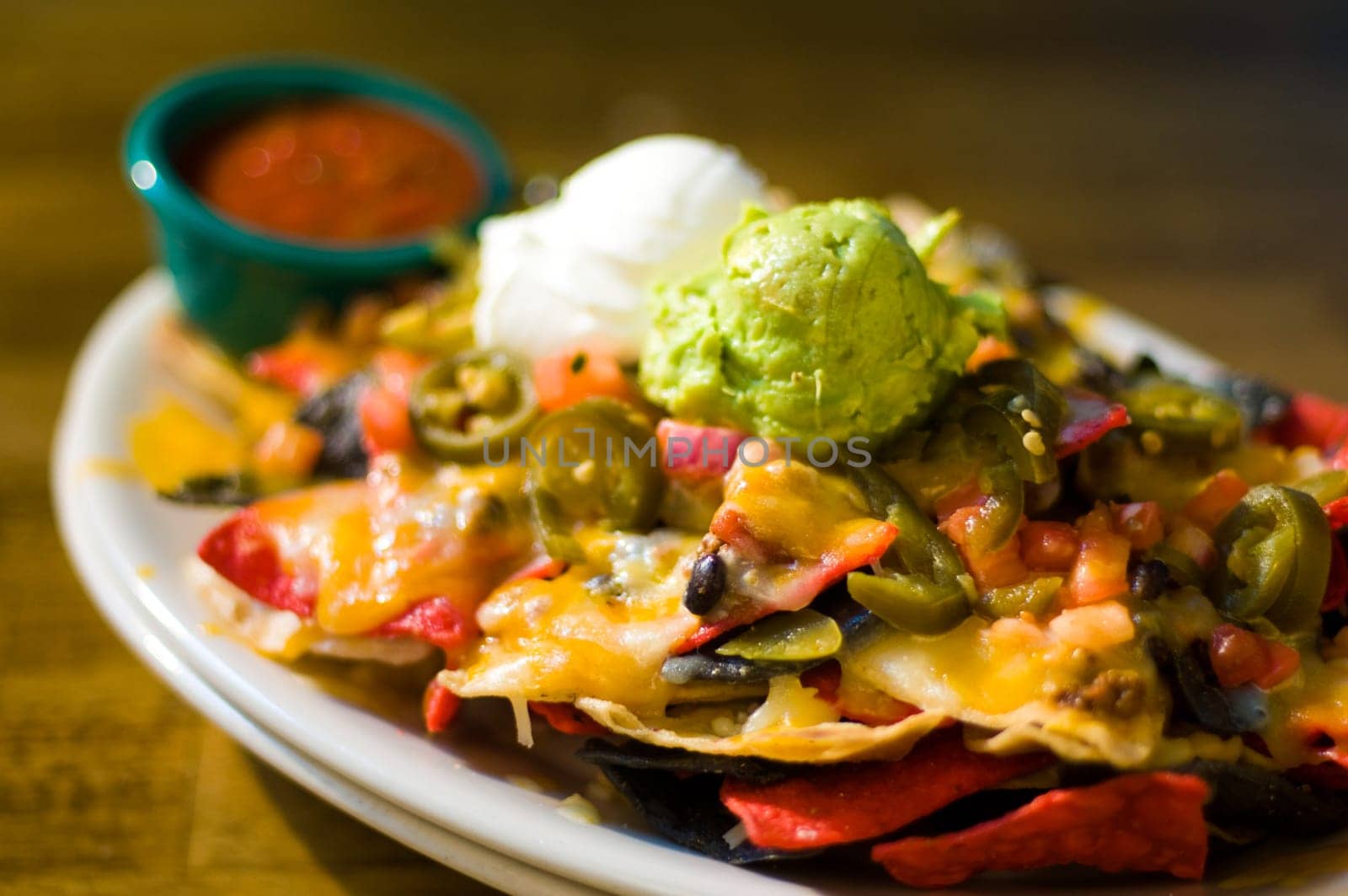 Nachos with cheese, guacamole, and sour cream