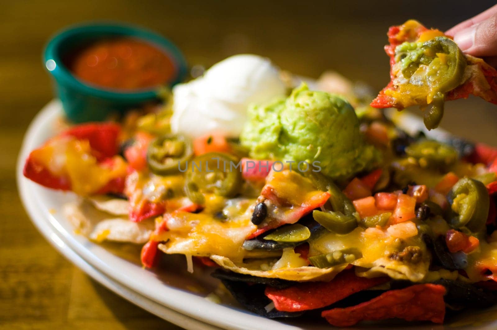 Nachos with cheese, guacamole, and sour cream