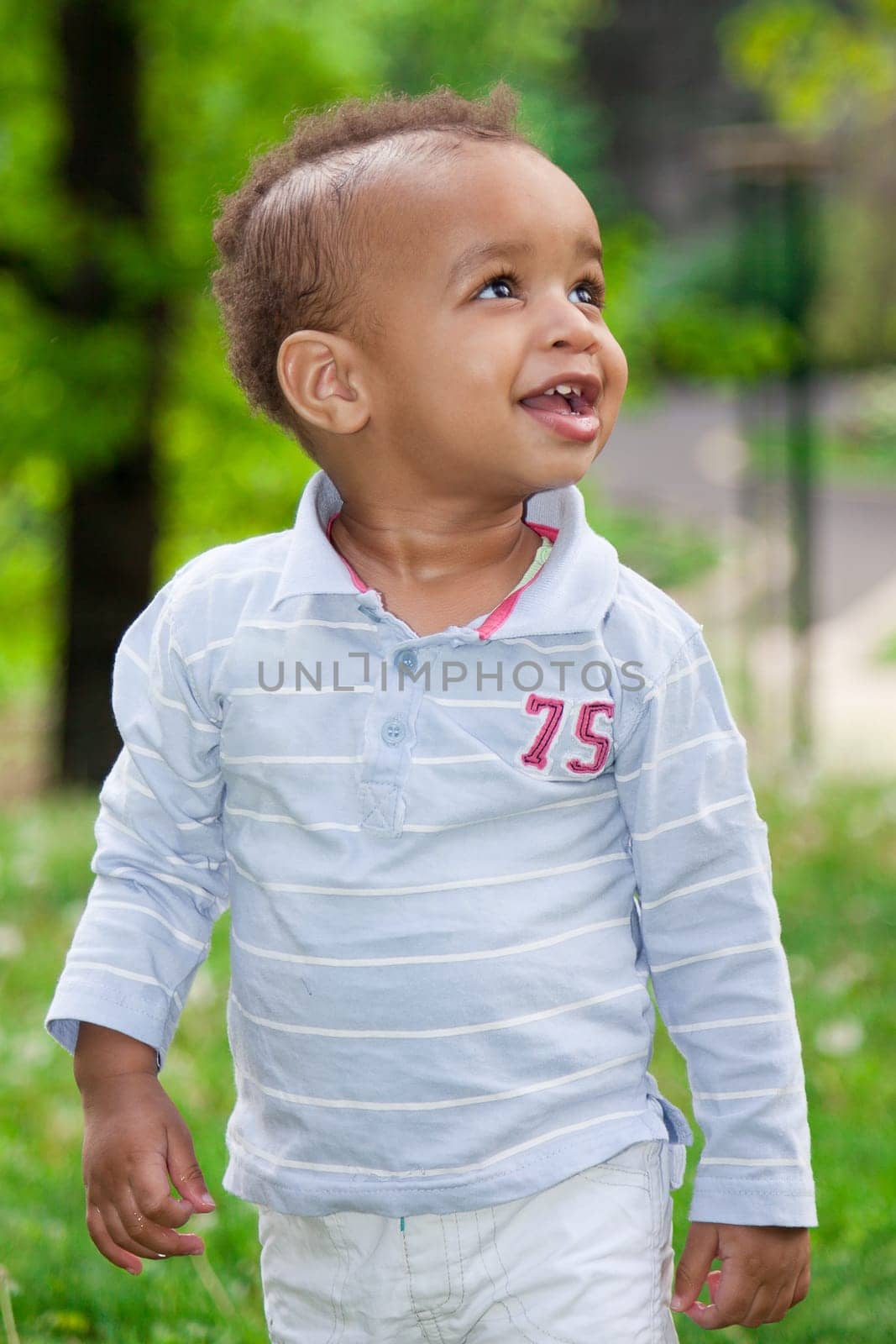 Portrait of a african american  baby boy playing  at the park