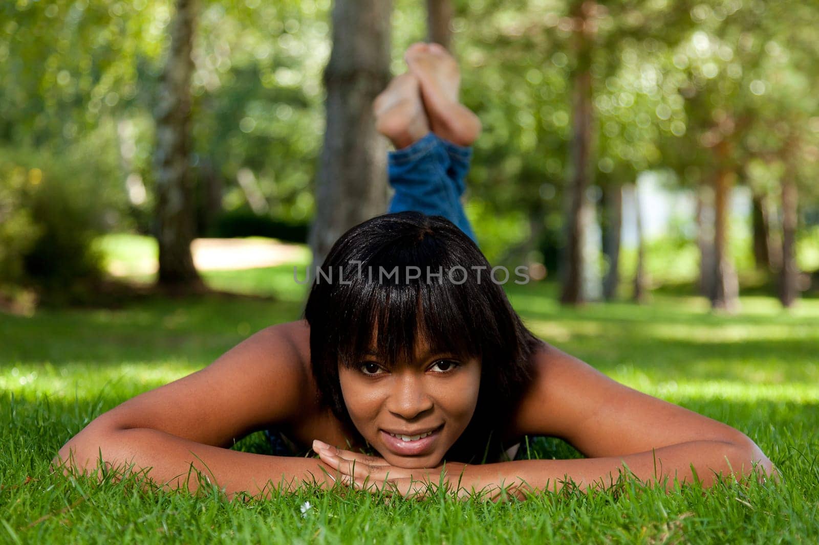 Young african american woman  lying on the grass