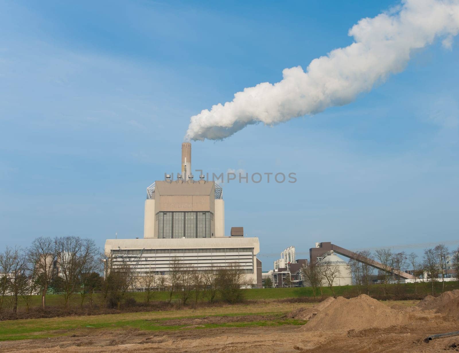 power plant with smoking chimney in Nijmegen, Netherlands