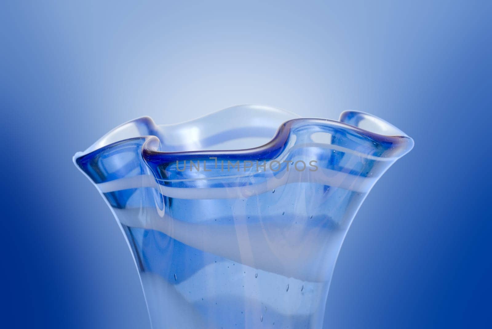 Closeup of a neck of a blue vase with curves (on white)