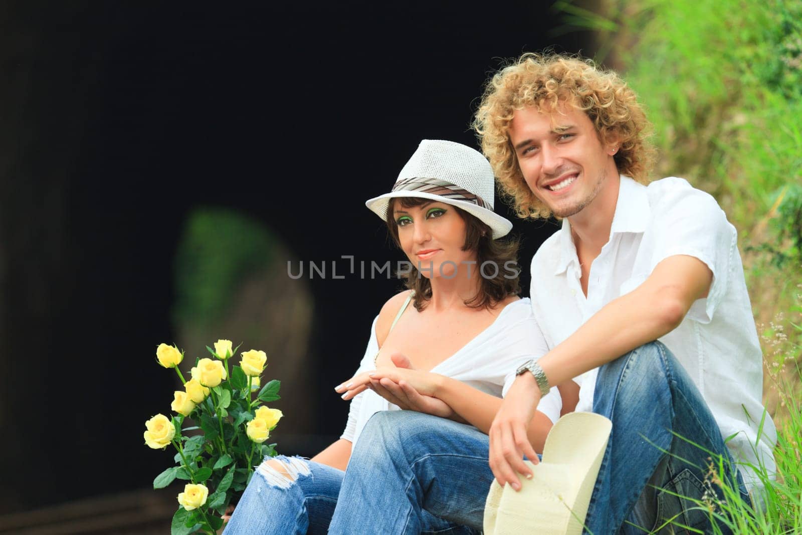 Young couple posing on a train tracks