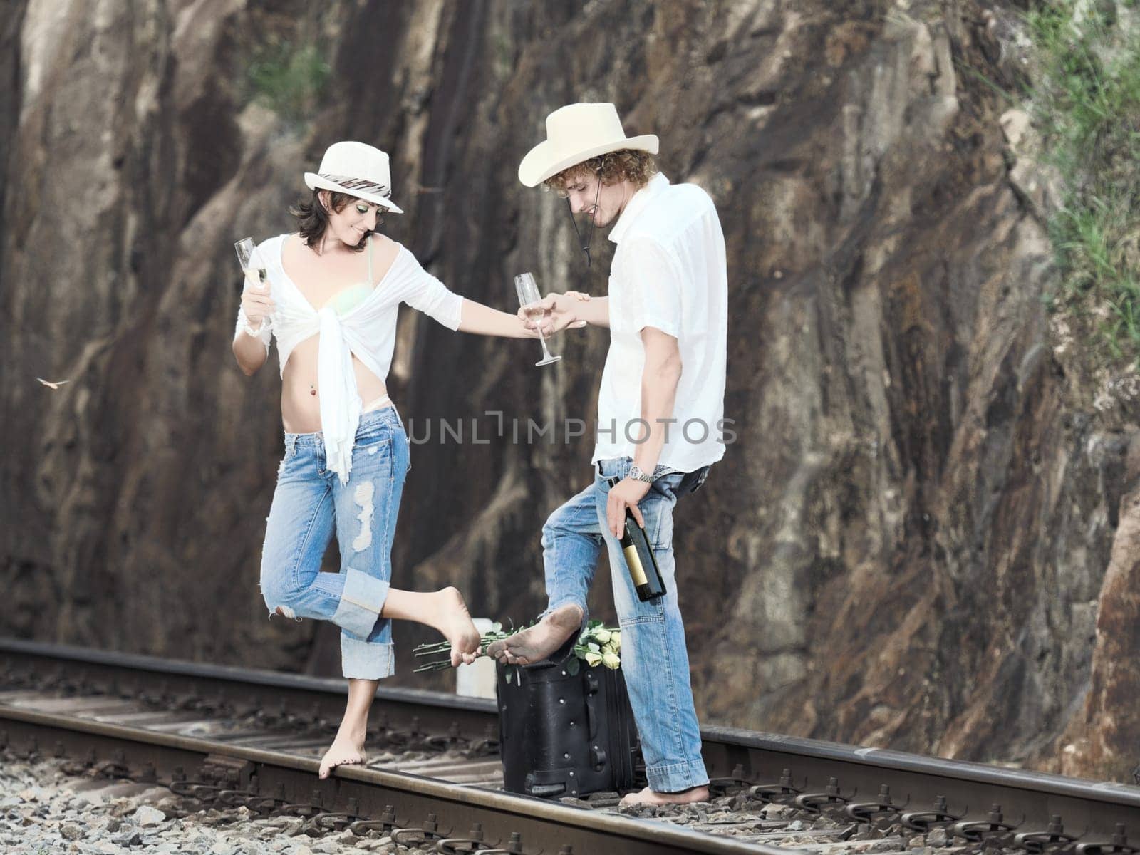 Young couple posing on a train tracks