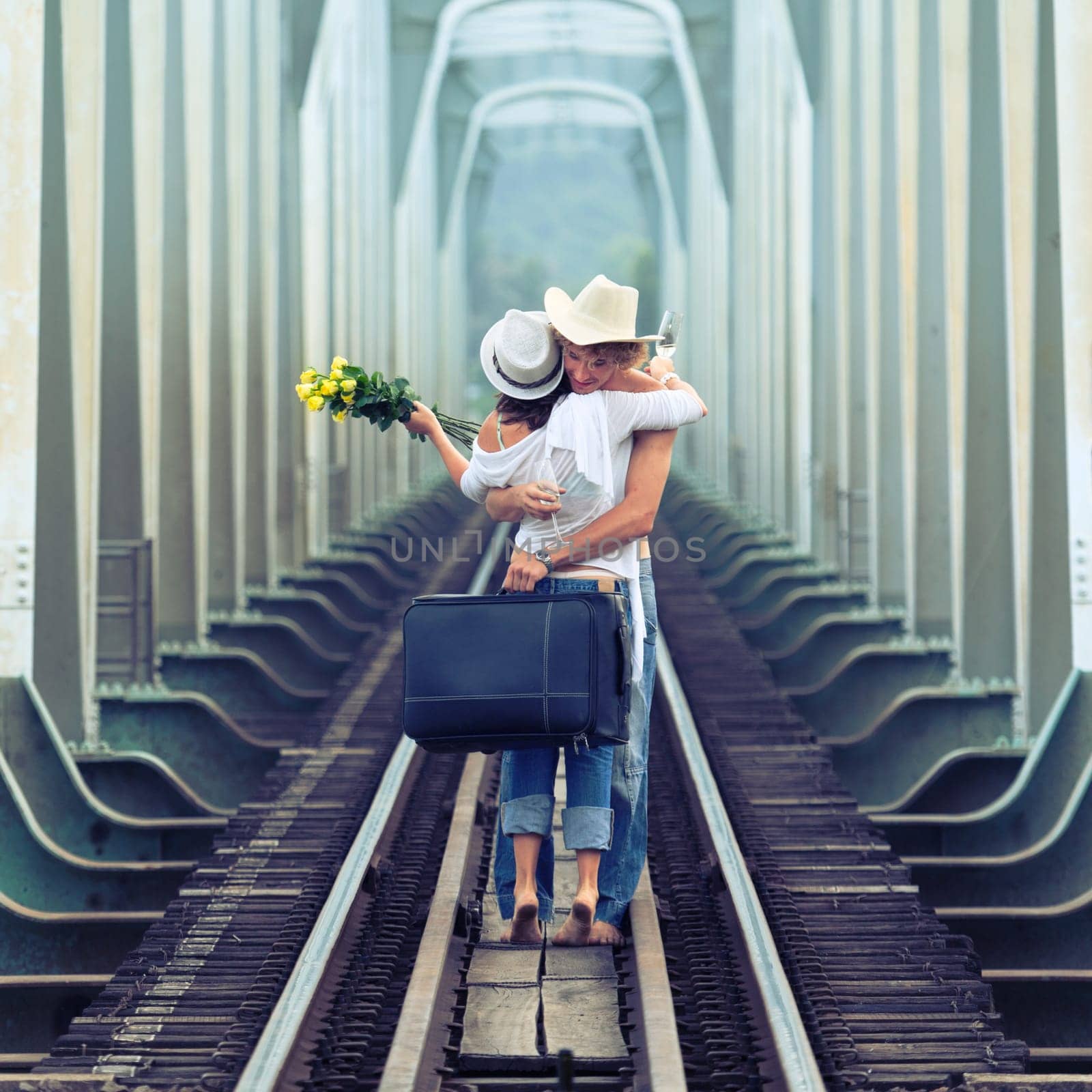 Young couple hugging on a train tracks