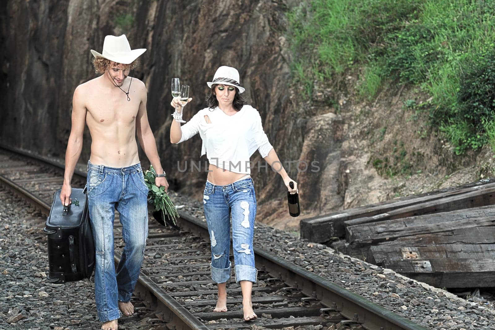 Young couple posing on a train tracks