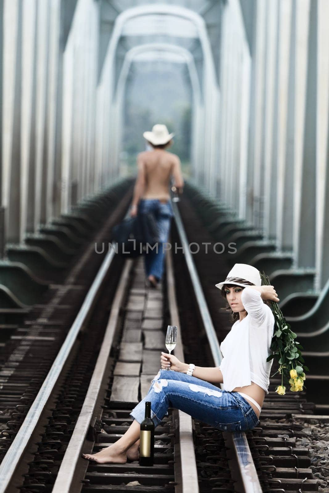 Young couple posing on a train tracks