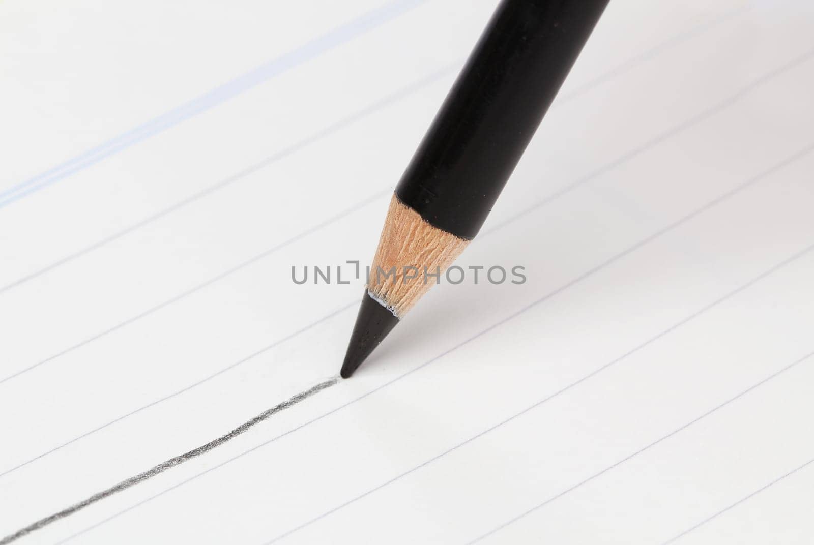 Writing hand with a blue pencil