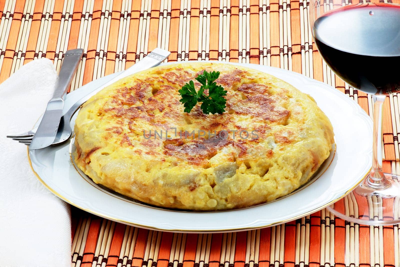 spanish omelet of potatoes and onion with a glass of red wine