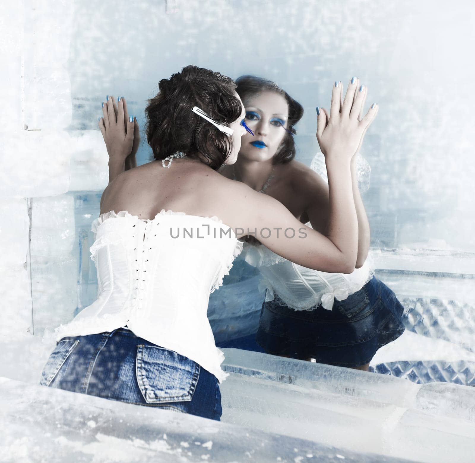 Woman as a snow queen in ice room