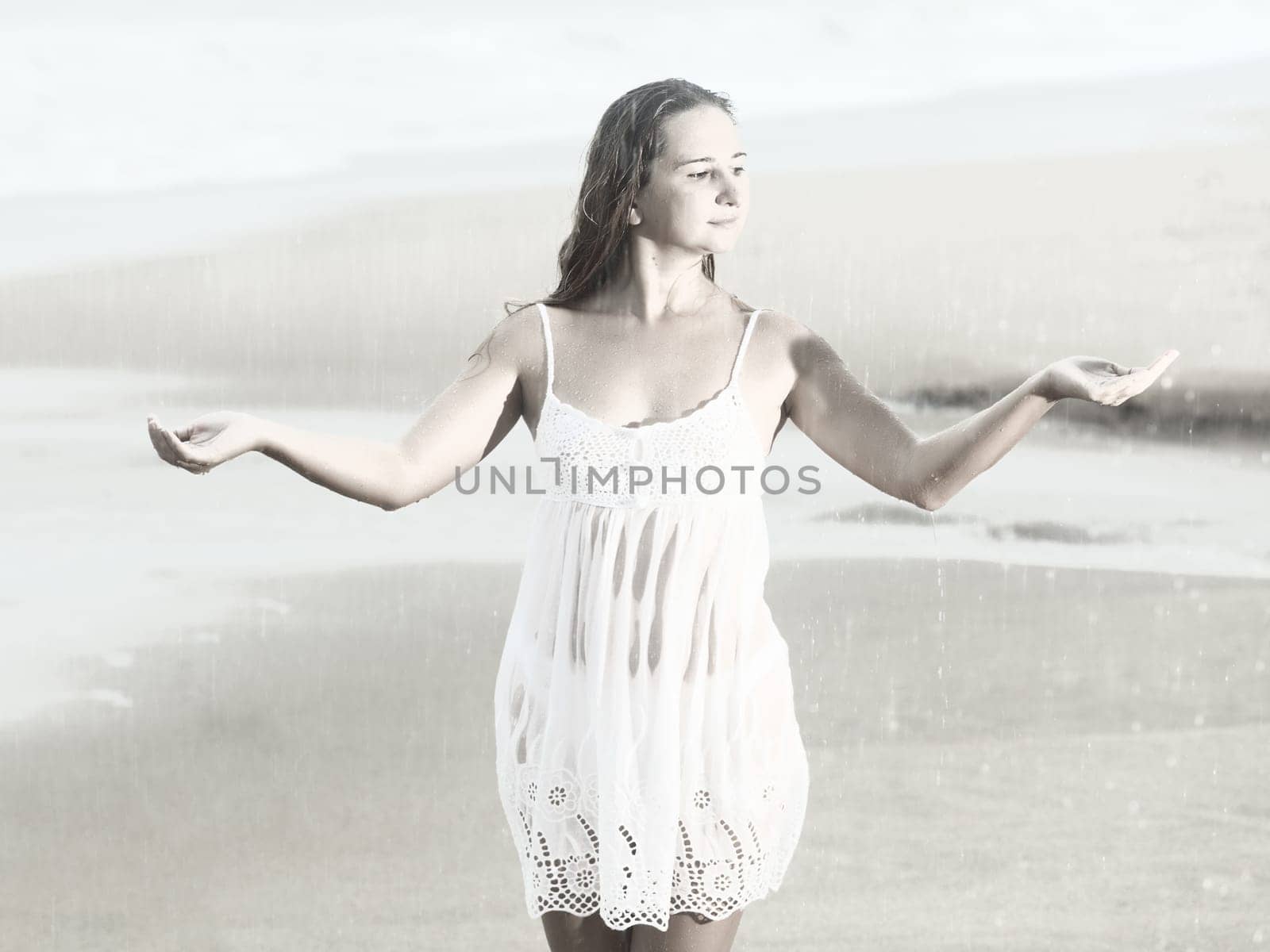 Beautiful woman near the stormy ocean at rain