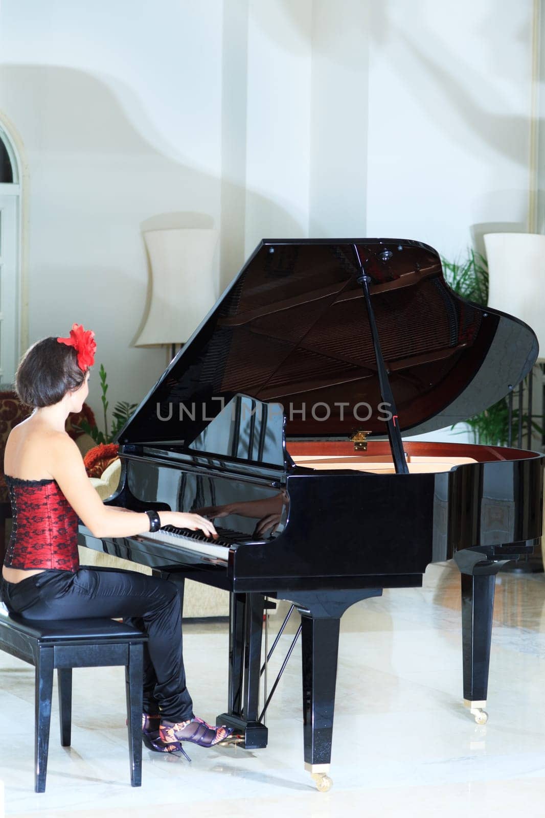 Attractive young woman playing on the piano