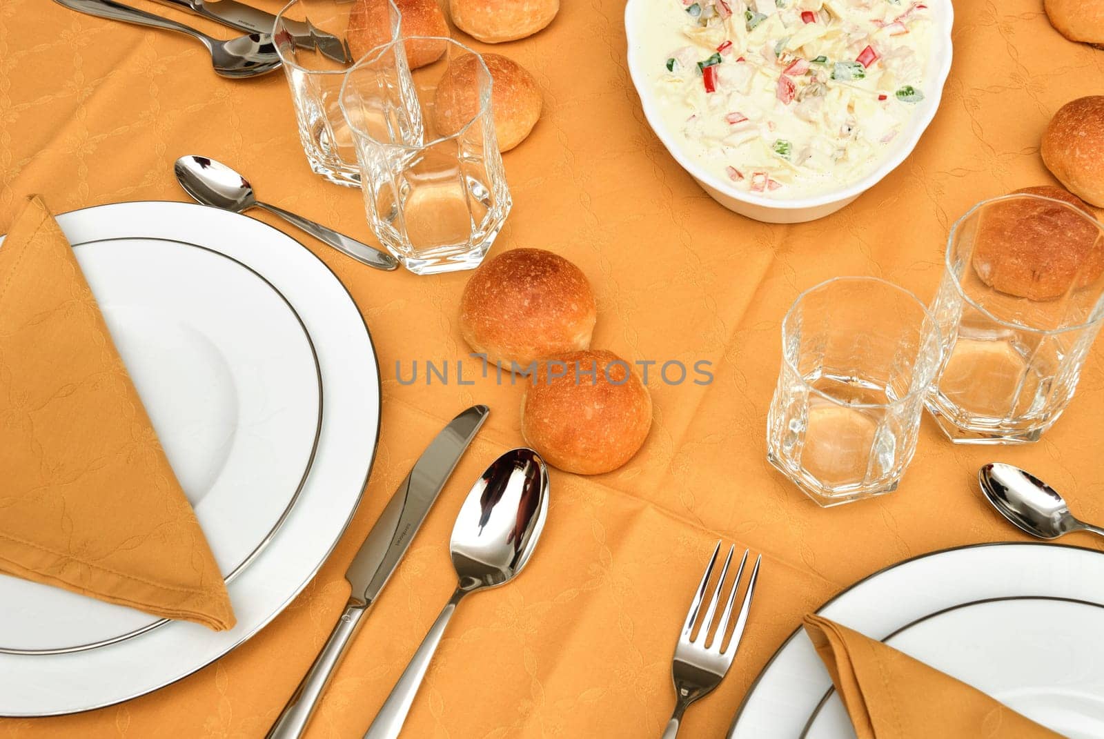 bread, plates  and salami on the table