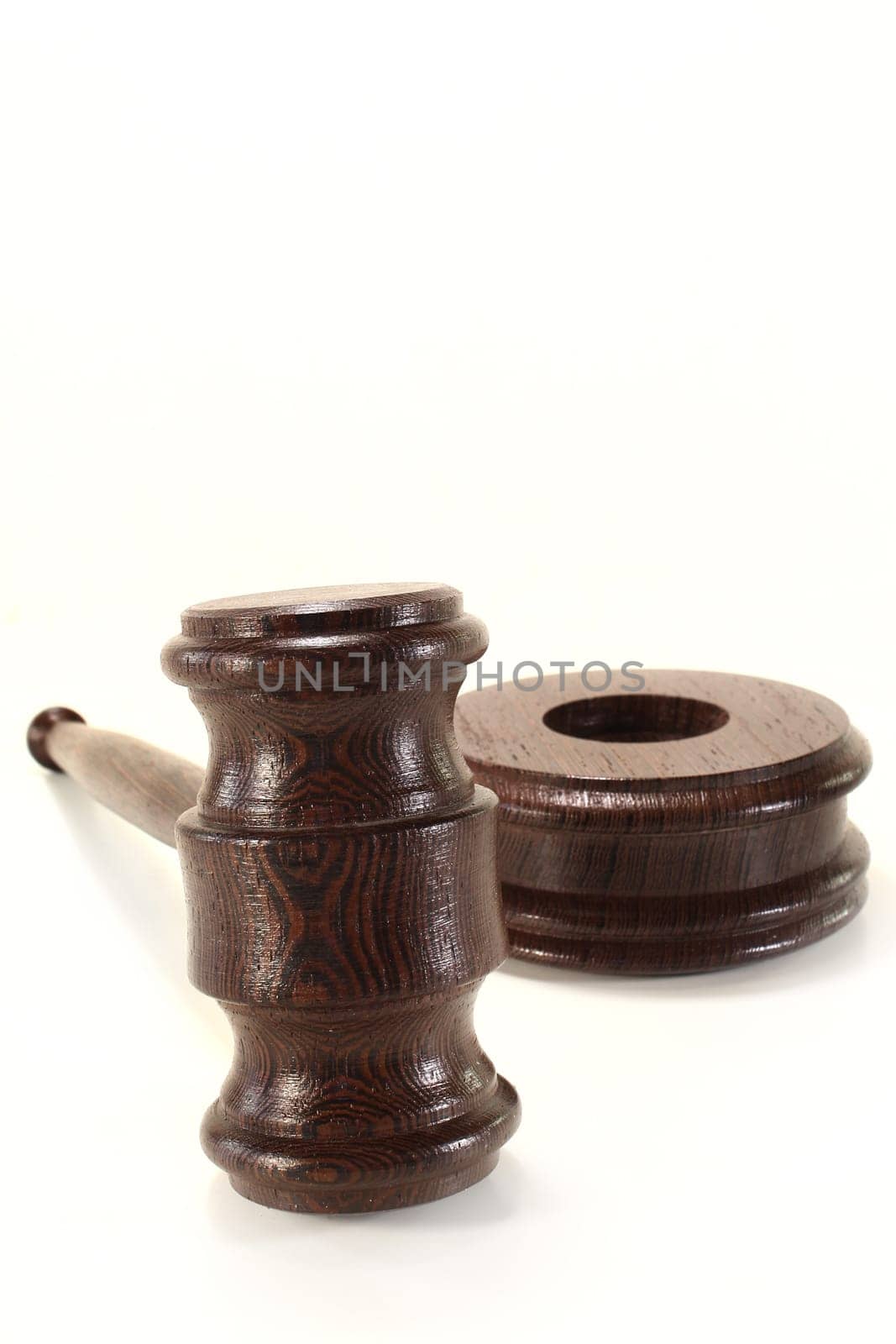 a brown judge's gavel against a white background