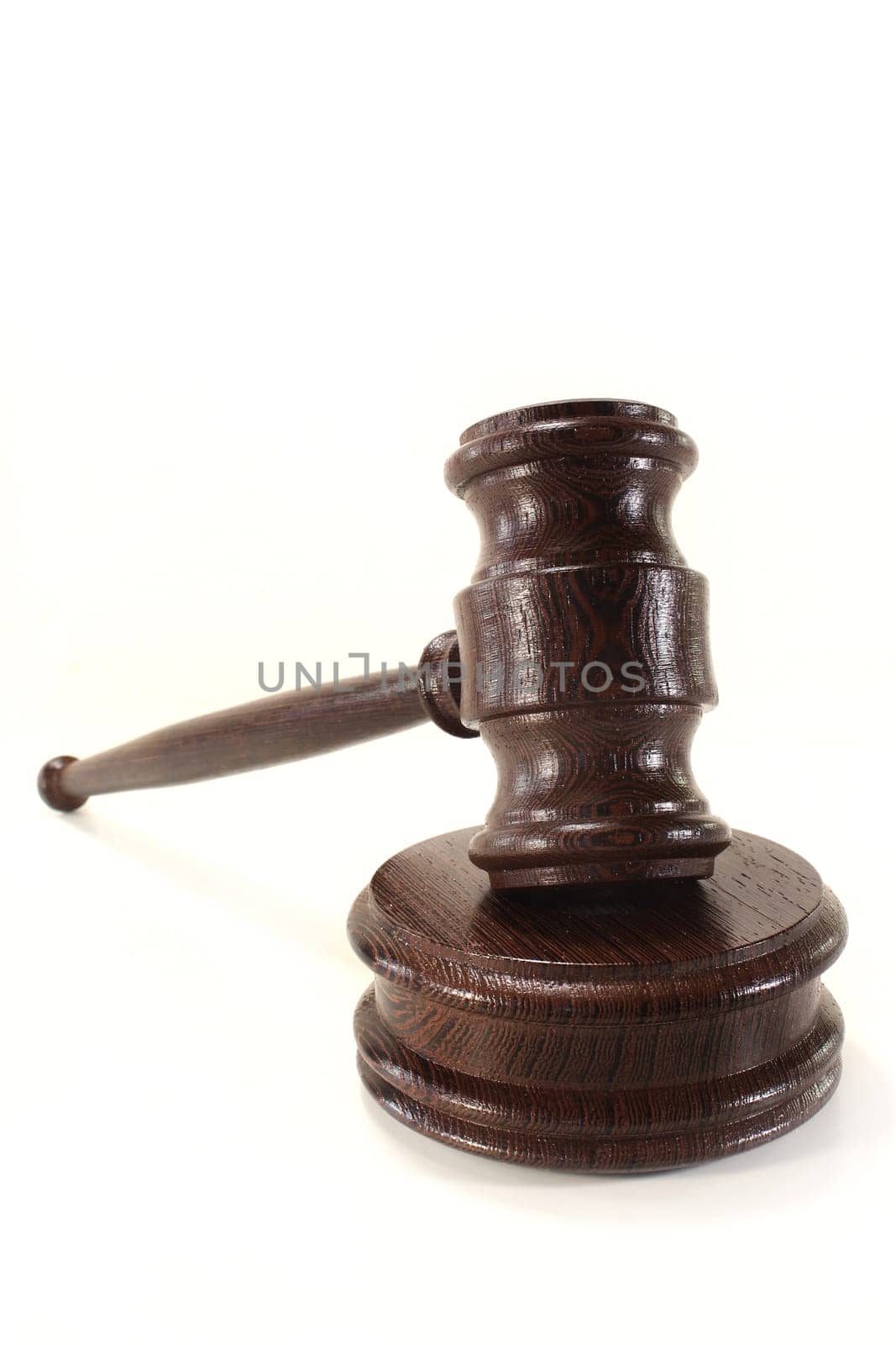 a brown judge's gavel against a white background