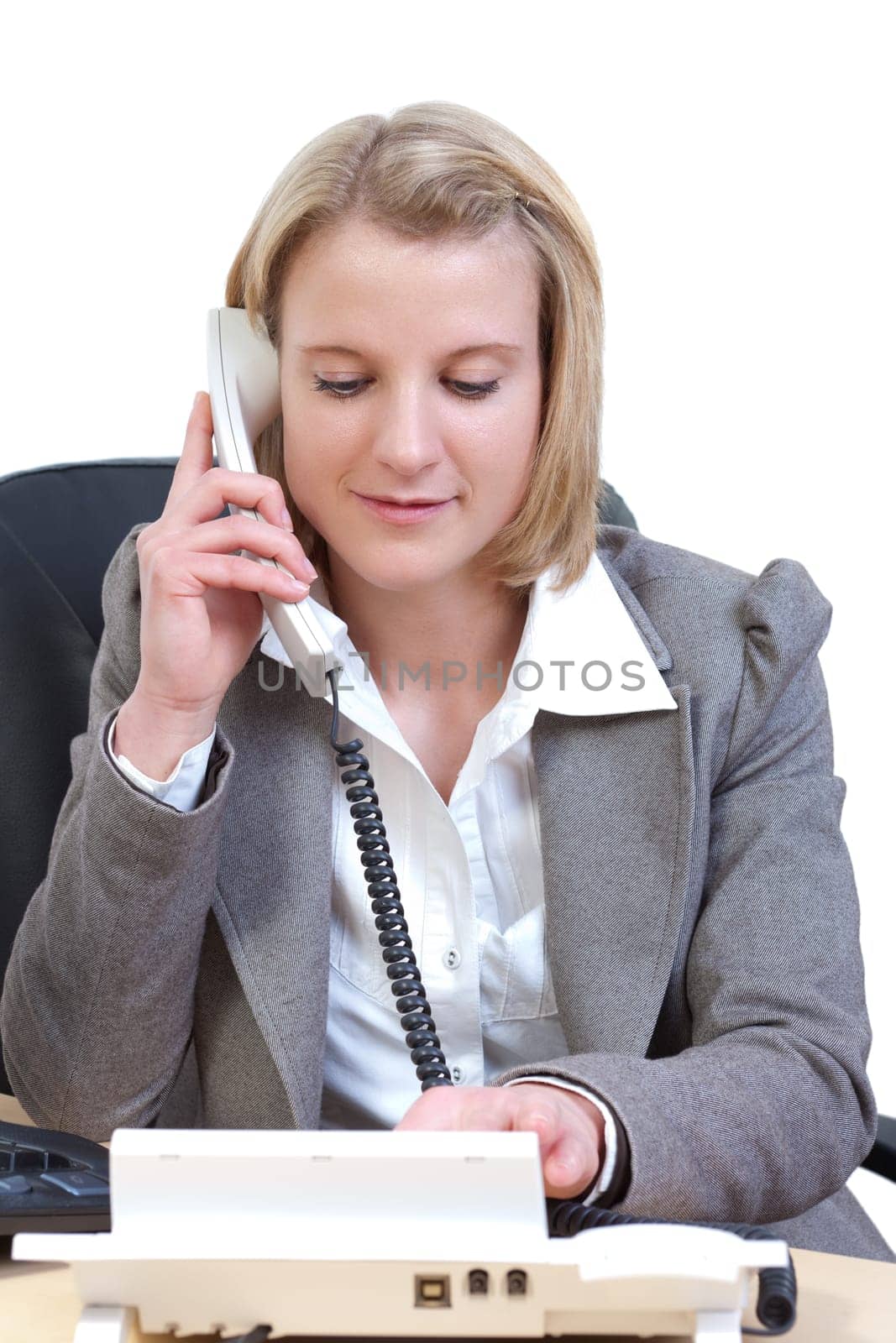 Young woman in office dials a phone number
