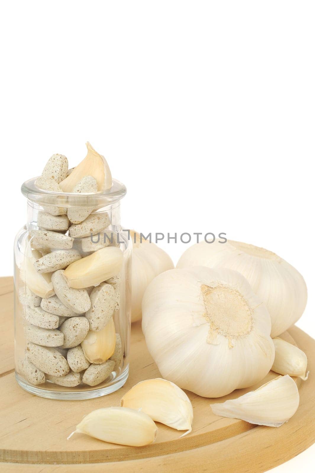 Garlic and herbal supplement pills isolated, alternative medicine concept