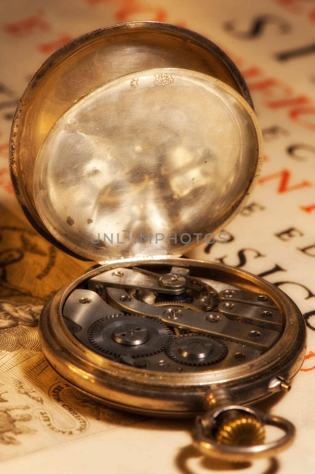 Antique clock onion on ancient book in Latin