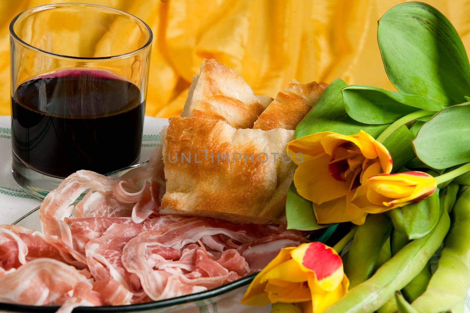 Typical Italian sausage sliced ??cake and flowers