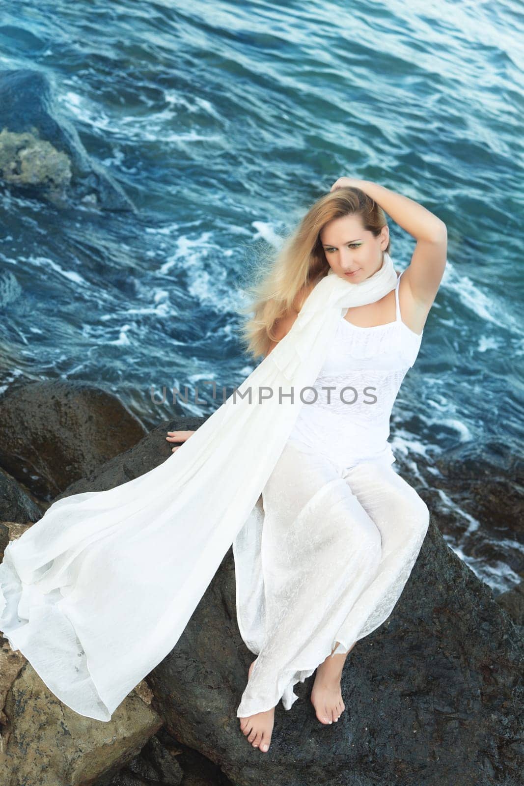 Young beautiful woman posing near the ocean