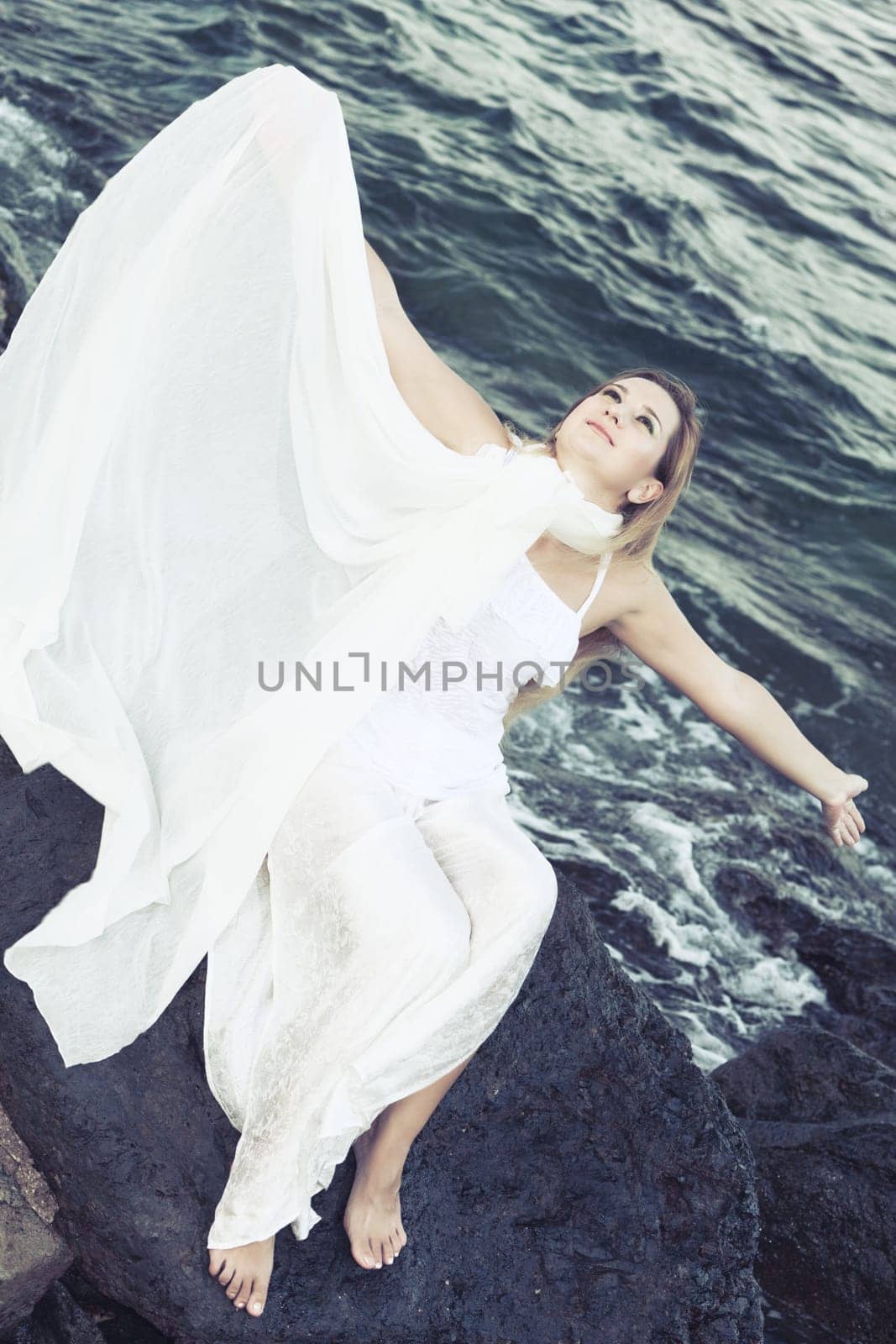 Young beautiful woman posing near the ocean